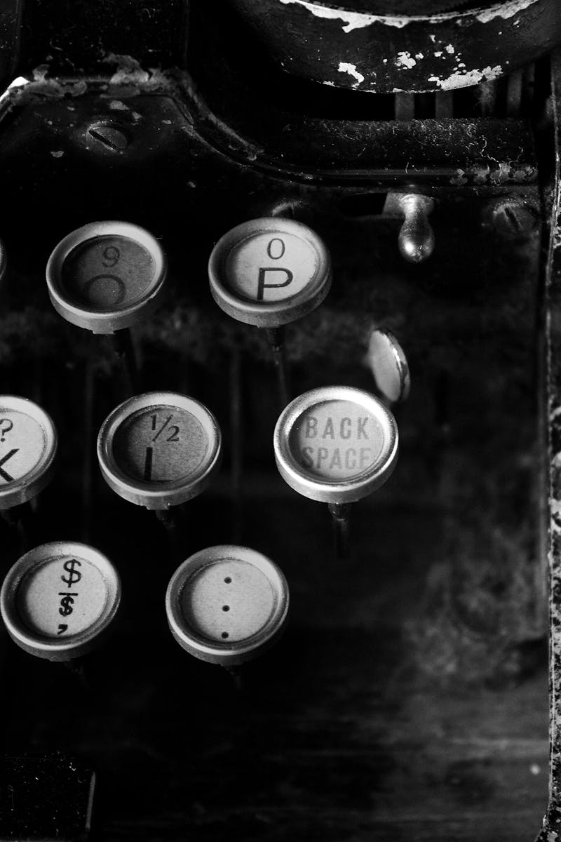 Close-up of antique typewriter keys in black and white, highlighting vintage design.